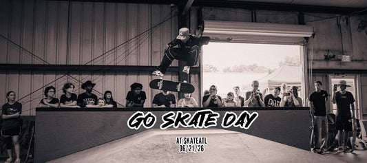 Skateboarder performing a kickflip during Go Skate Day 2026 at Skate ATL while spectators watch from the sidelines.